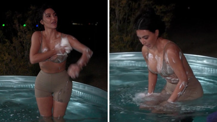 Kim Kardashian Soaps Herself Up in Pool Whereas Tenting, on Video