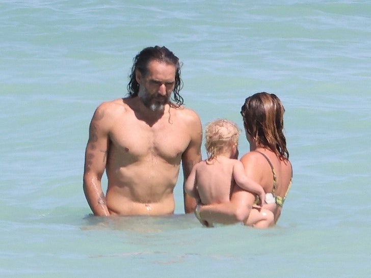 Russell Model Hits Seashore For Stress-free Household Day After Being Charged with Rape