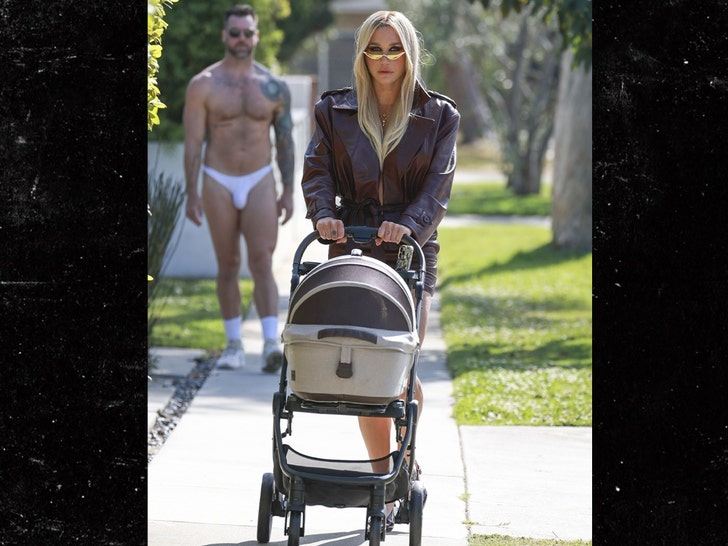 Kesha Walks Cat in Stroller as Man in Jockstrap Lurks in Weird Photoshoot